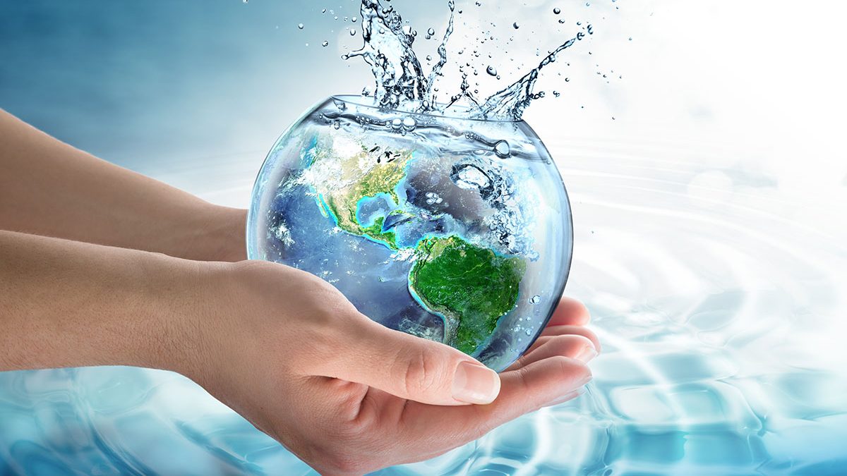 Mãos humanas segurando uma gota d'água que representa o planeta terra